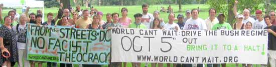 large group posing with two banners