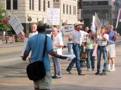 An activist confronts an anti-immigrant group