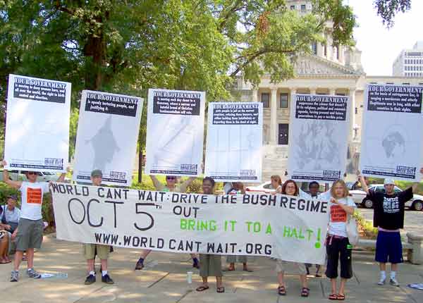 Outside the capitol with 7 "Your Gov" charges on signs