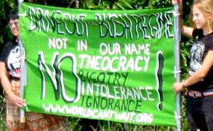 Two people holding an anti-theocracy banner