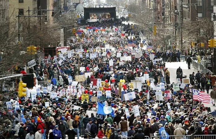   Â  Â  Protesters near the UN on Feb. `15 2003. See the Not in Our Name globe flag in the lower center.